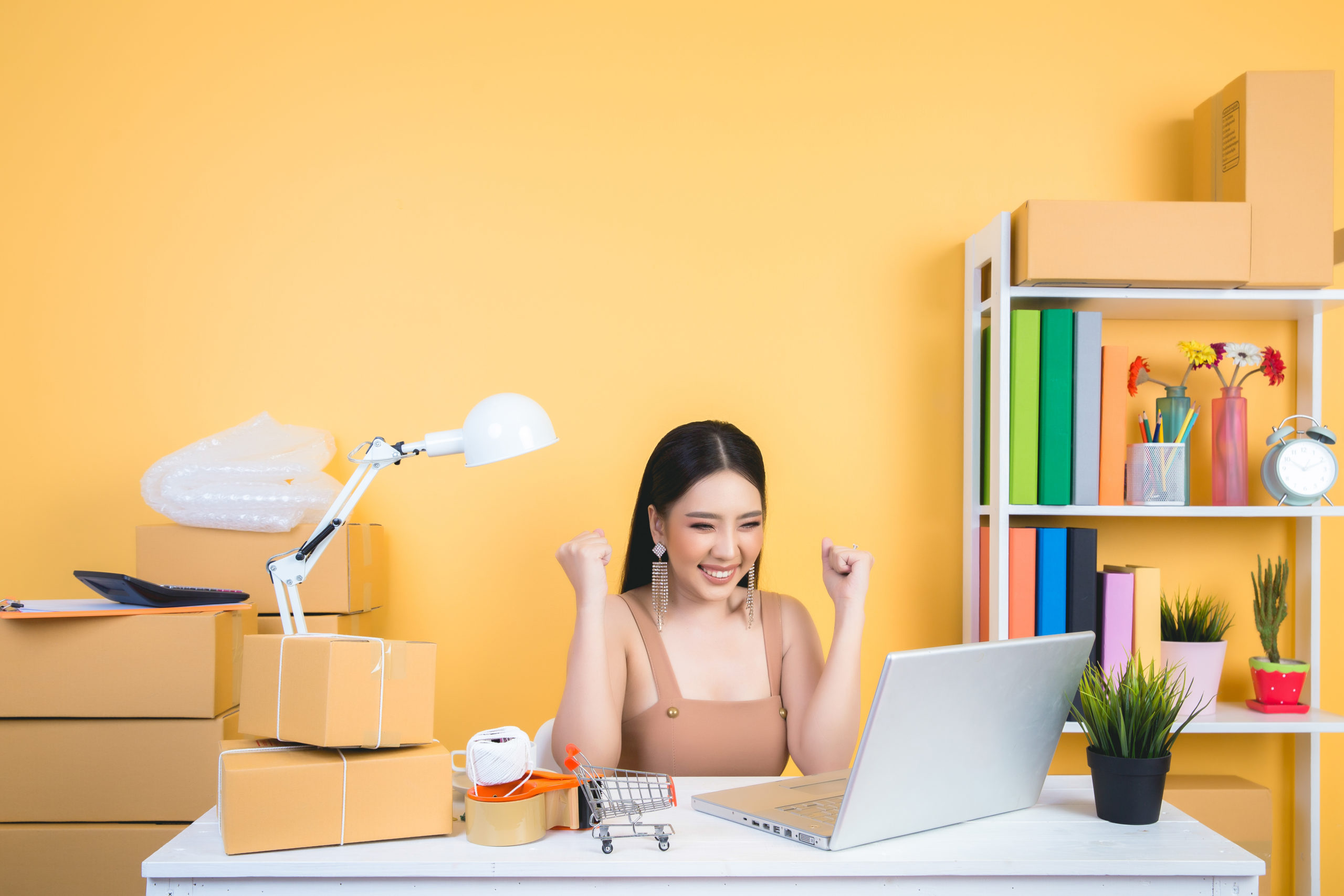 business owner working at home office packaging on background.