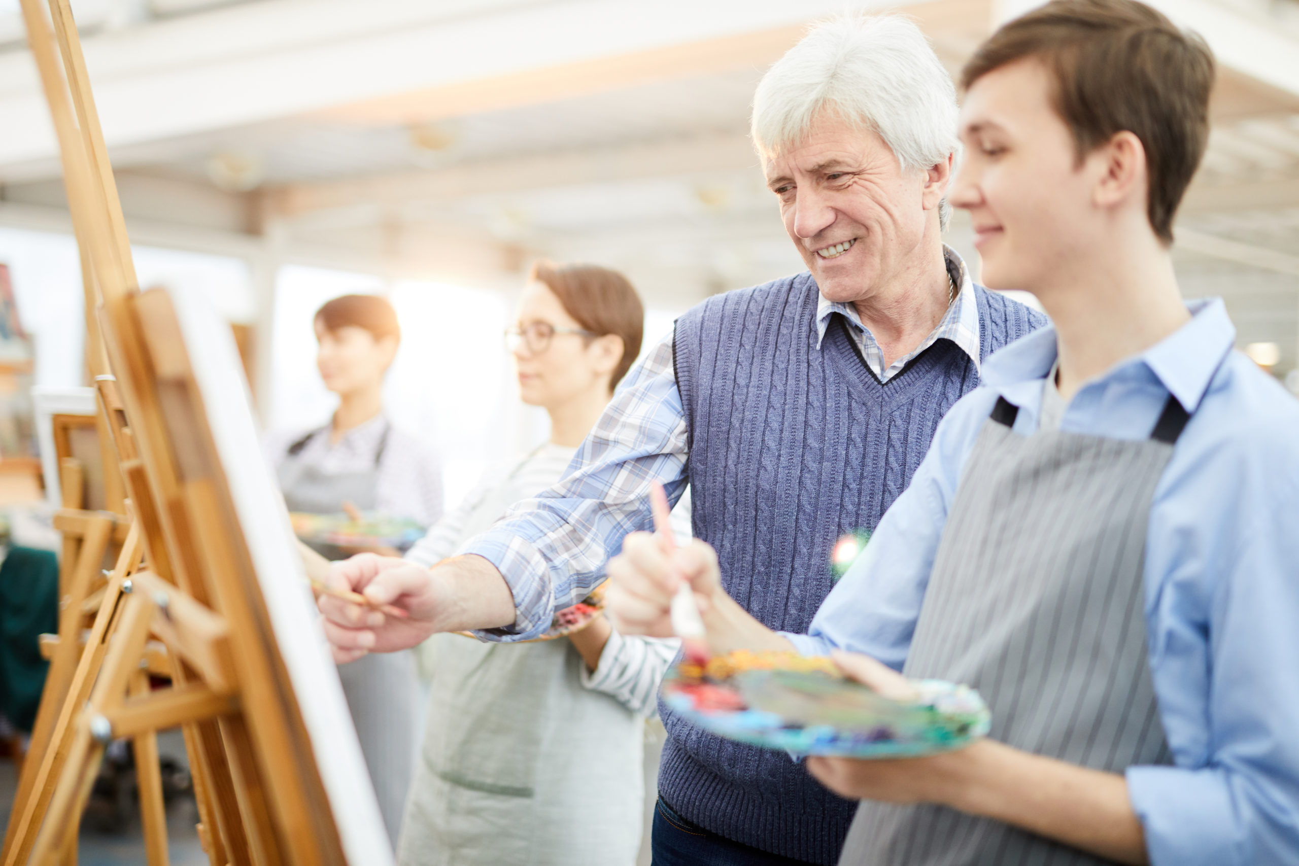 Smiling Art Teacher Helping Students