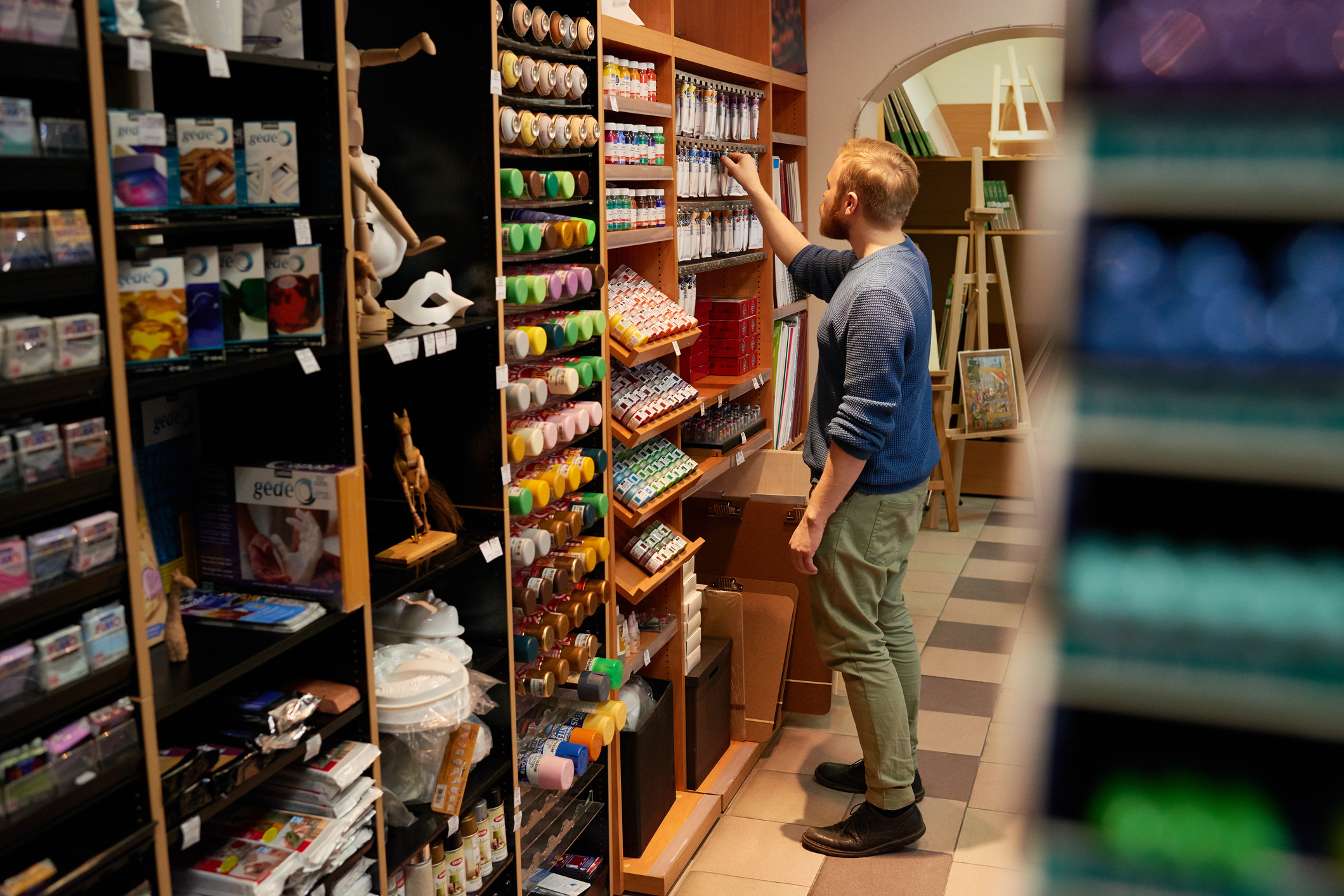 Guy choosing paint in modern store